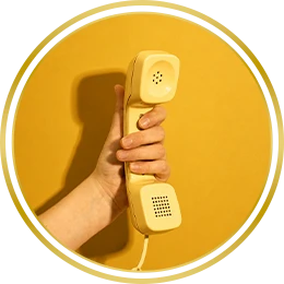 Vintage cream telephone handset on a yellow background